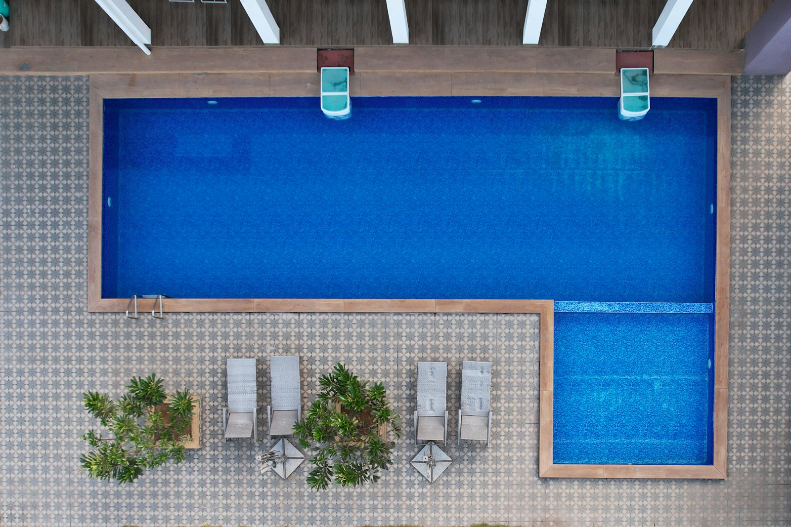 Clean blue-tile pool with lounge seating