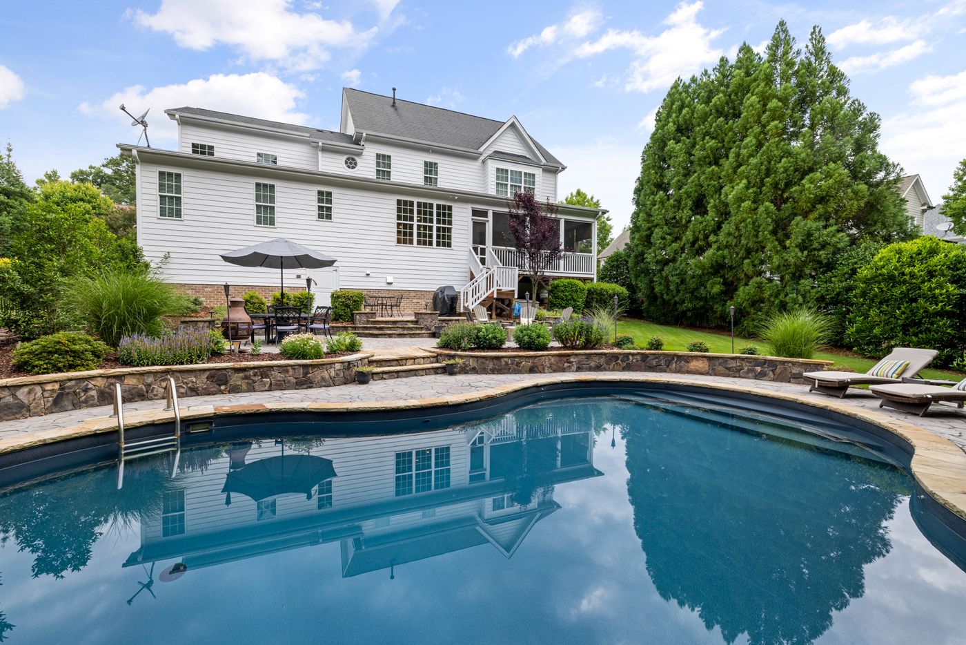 Large backyard pool with open lawn