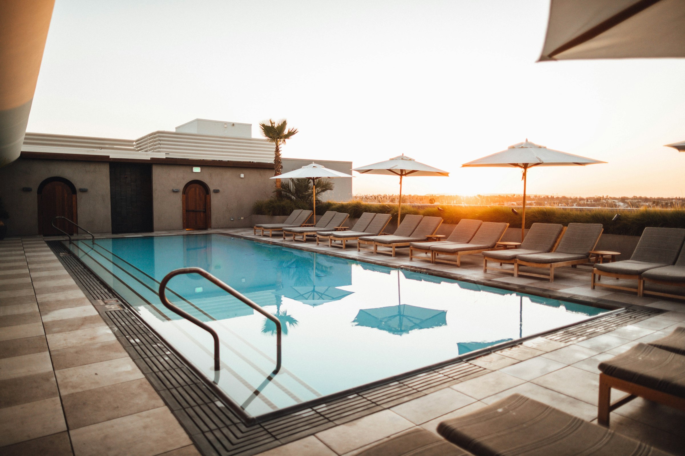 A backyard swimming pool glowing at golden hour in Arizona